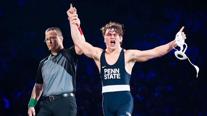A bloodied Tyler Kasak of Penn State celebrates after defeating Iowa's Jacori Teemer 5-2 in their 157-pound bout at the Bryce Jordan Center. 