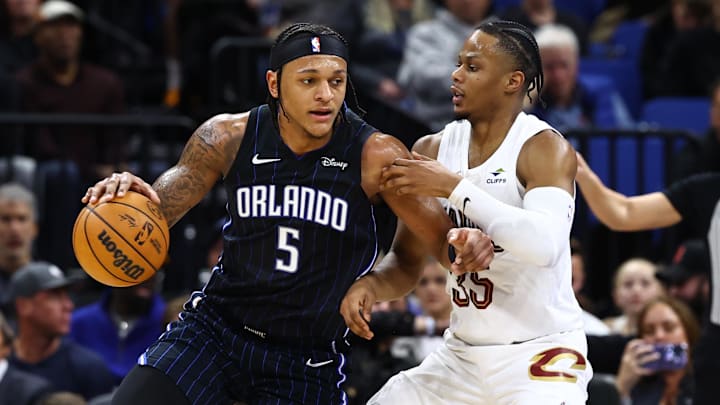 Cleveland Cavaliers forward Isaac Okoro (35) defends Orlando Magic forward Paolo Banchero.