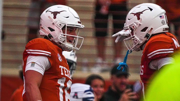 Texas Longhorns quarterback Arch Manning (16) and receiver DeAndre Moore Jr. (0) celebrate a touchdown by Manning during the game against UTSA at Darrell K Royal-Texas Memorial Stadium in Austin Saturday, Sept. 14, 2024.