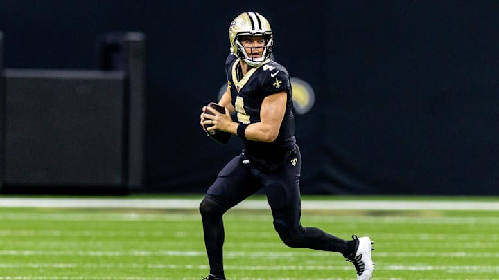 Nov 17, 2024; New Orleans, Louisiana, USA;  New Orleans Saints quarterback Derek Carr (4) rolls out the pocket against the Cleveland Browns during the first half at Caesars Superdome. Mandatory Credit: Stephen Lew-Imagn Images