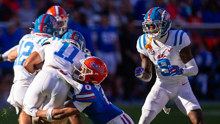 Florida Gators defensive back Sharif Denson (0) tackles Mississippi Rebels wide receiver Jordan Watkins (11) during the second half at Ben Hill Griffin Stadium in Gainesville, FL on Saturday, November 23, 2024. The Gators defeated the Rebels 24-17 [Doug Engle/Gainesville Sun]