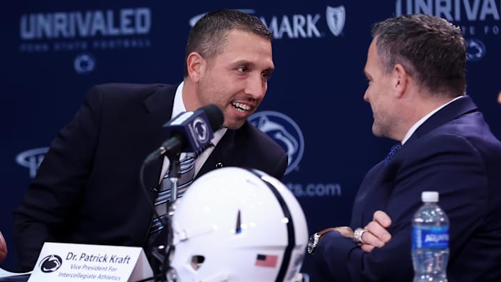 Dec 8, 2025; University Park, PA, USA; Matt Campbell, left, speaks with Penn State University athletic director Pat Kraft, right, while being announced as the Penn State Nittany Lions new head coach during a press conference at the Beaver Stadium Press Room. Mandatory Credit: Matthew O'Haren-Imagn Images