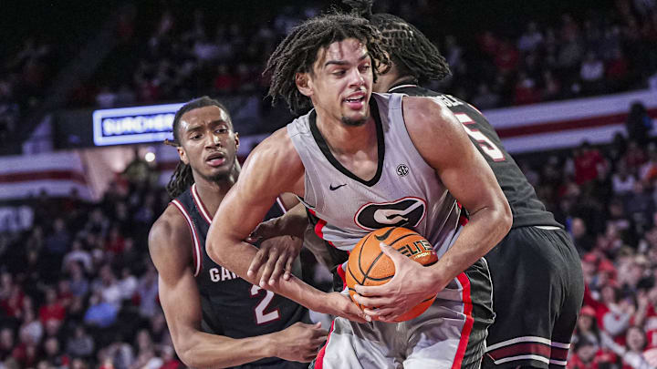 Jan 28, 2025; Athens, Georgia, USA; Georgia Bulldogs forward Asa Newell (14) grabs a rebound between South Carolina Gamecocks guard Zachary Davis (2) and forward Nick Pringle (5) during the second half at Stegeman Coliseum. Mandatory Credit: Dale Zanine-Imagn Images