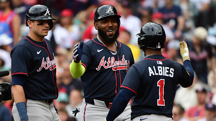 May 18, 2025; Boston, Massachusetts, USA;  Atlanta Braves designated hitter Marcell Ozuna (20) is congratulated by second baseman Ozzie Albies (1) after hitting a three run home run during the eighth inning against the Boston Red Sox at Fenway Park. Mandatory Credit: Bob DeChiara-Imagn Images