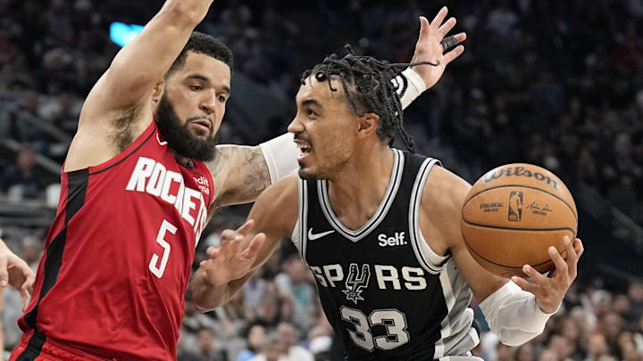 Mar 12, 2024; San Antonio, Texas, USA; San Antonio Spurs guard Tre Jones (33) drives to the basket while defended by Houston Rockets guard Fred VanVleet (5) during the second half at Frost Bank Center.