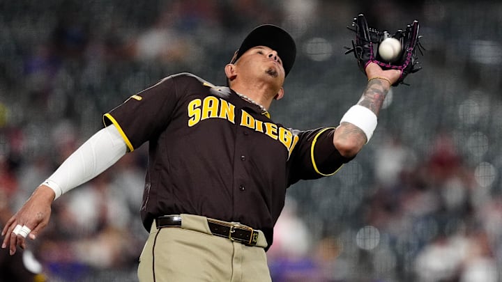 Apr 21, 2026; Denver, Colorado, USA; San Diego Padres third baseman Manny Machado (13) fields a ball in the eighth inning against the Colorado Rockies at Coors Field. Mandatory Credit: Ron Chenoy-Imagn Images