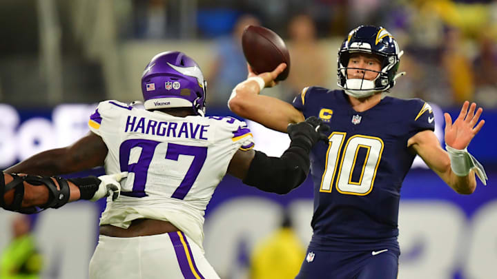 Oct 23, 2025; Inglewood, California, USA; Minnesota Vikings defensive tackle Javon Hargrave (97) gets pressure on Los Angeles Chargers quarterback Justin Herbert (10) during the first half at SoFi Stadium. Mandatory Credit: Gary A. Vasquez-Imagn Images
