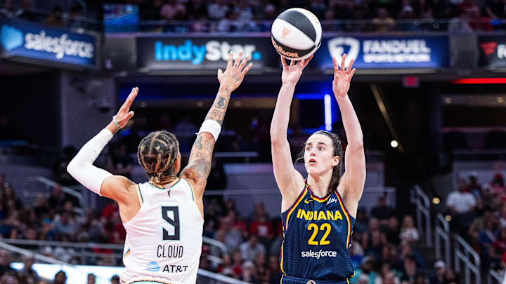 Jun 14, 2025; Indianapolis, Indiana, USA; Indiana Fever guard Caitlin Clark (22) shoots the ball while New York Liberty guard Natasha Cloud (9) defends in the first half at Gainbridge Fieldhouse. Mandatory Credit: Trevor Ruszkowski-Imagn Images