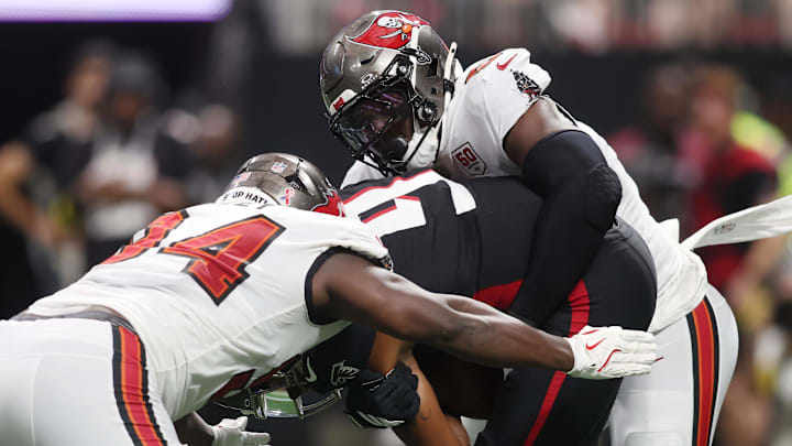 Sep 7, 2025; Atlanta, Georgia, USA; Tampa Bay Buccaneers linebacker Yaya Diaby (0) and defensive tackle Calijah Kancey (94) tackle Atlanta Falcons quarterback Michael Penix Jr. (9) during the second quarter at Mercedes-Benz Stadium. Mandatory Credit: Brett Davis-Imagn Images