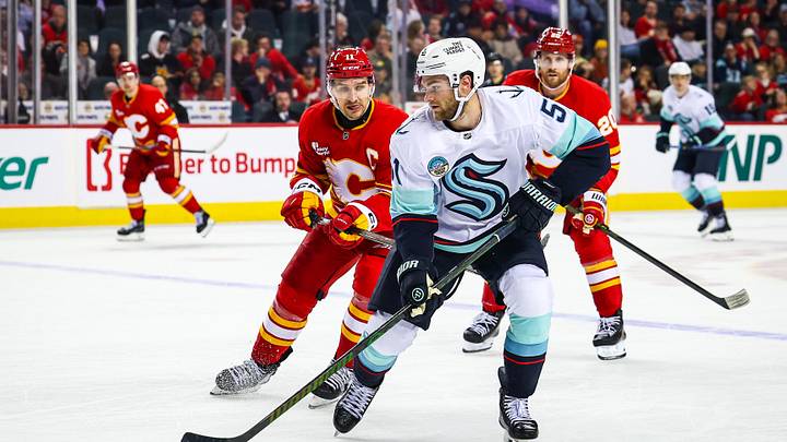 Jan 5, 2026; Calgary, Alberta, CAN; Seattle Kraken center Shane Wright (51) controls the puck against the Calgary Flames during the third period at Scotiabank Saddledome. Mandatory Credit: Sergei Belski-Imagn Images