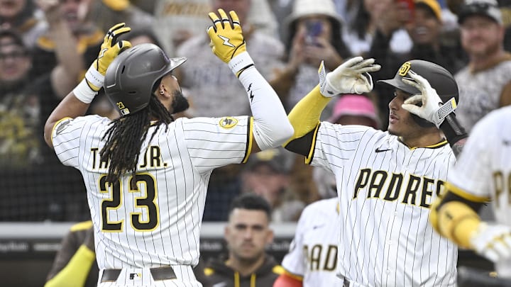 May 27, 2025; San Diego, California, USA; San Diego Padres outfielder Fernando Tatis Jr. (23) is congratulated by  Manny Machado (13) after hitting a solo home run during the first inning against the Miami Marlins at Petco Park. Mandatory Credit: Denis Poroy-Imagn Images
