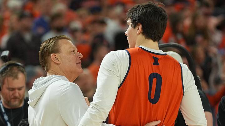 Apr 3, 2026; Indianapolis, IN, USA; Illinois Fighting Illini head coach Brad Underwood talks with forward David Mirkovic (0) during a practice session ahead of the Final Four of the men's 2026 NCAA Tournament at Lucas Oil Stadium. Mandatory Credit: Robert Deutsch-Imagn Images