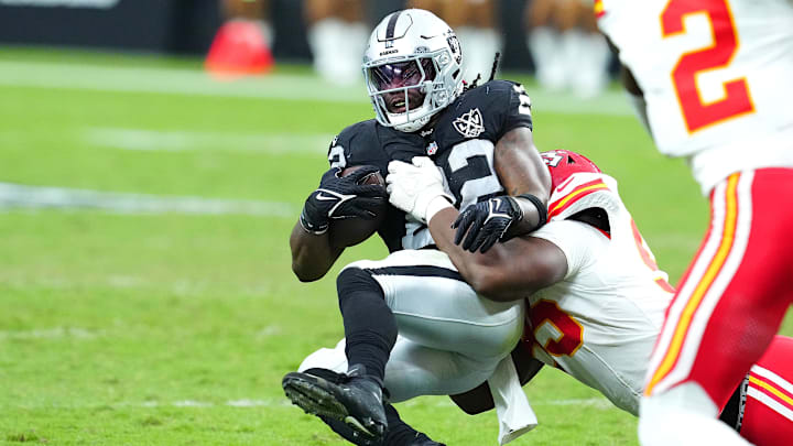 Oct 27, 2024; Paradise, Nevada, USA; Las Vegas Raiders running back Alexander Mattison (22) is tackled by Kansas City Chiefs defensive tackle Tershawn Wharton (98) during the third quarter at Allegiant Stadium. Mandatory Credit: Stephen R. Sylvanie-Imagn Images Oct 27, 2024; Paradise, Nevada, USA; Las Vegas Raiders running back Alexander Mattison (22) is tackled by Kansas City Chiefs defensive tackle Tershawn Wharton (98) during the third quarter at Allegiant Stadium. Mandatory Credit: Stephen R. Sylvanie-Imagn Images