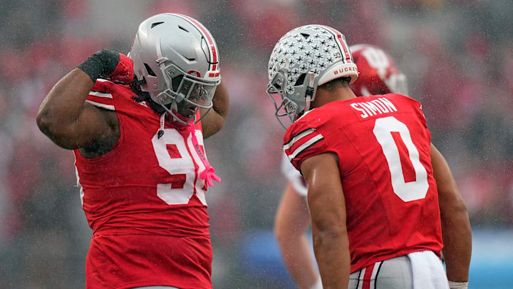 Ohio State Buckeyes linebacker Cody Simon (0) celebrates his sack of Indiana Hoosiers quarterback Kurtis Rourke (9) with Ohio State Buckeyes defensive lineman Kayden McDonald (98) during the second quarter of the football game in Columbus on Saturday, Nov. 23, 2024.