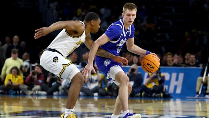 Mar 20, 2025; Wichita, KS, USA; Drake Bulldogs guard Bennett Stirtz (14) dribbles against Missouri Tigers guard Tony Perkins (12) in the first half of a first round men’s NCAA Tournament game at Intrust Bank Arena. Mandatory Credit: Nick Tre. Smith-Imagn Images