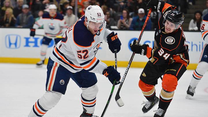 February 25, 2020; Anaheim, California, USA; Edmonton Oilers right wing Patrick Russell (52) shoots on goal as Anaheim Ducks center Sam Steel (34) moves in to defend  during the first period at Honda Center. Mandatory Credit: Gary A. Vasquez-Imagn Images