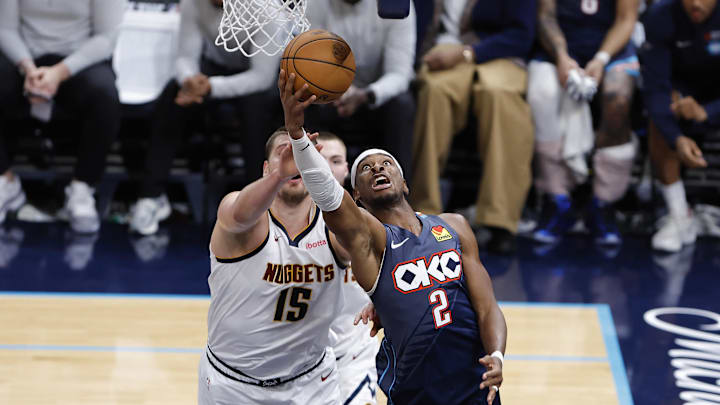 Feb 27, 2026; Oklahoma City, Oklahoma, USA; Oklahoma City Thunder guard Shai Gilgeous-Alexander (2) goes up for a basket in front of Denver Nuggets center Nikola Jokić (15) during the fourth quarter at Paycom Center. Mandatory Credit: Alonzo Adams-Imagn Images