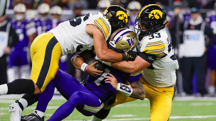 Oct 9, 2026; Seattle, Washington, USA; Iowa Hawkeyes linebacker Cam Buffington (33) and linebacker Jayden Montgomery (36) sack Washington Huskies quarterback Demond Williams Jr. (1) during the first quarter at Husky Stadium. Mandatory Credit: Joe Nicholson-Imagn Images