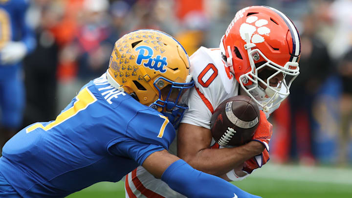 Nov 16, 2024; Pittsburgh, Pennsylvania, USA; Clemson Tigers wide receiver Antonio Williams (0) catches a touchdown pass against Pittsburgh Panthers defensive back Javon McIntyre (7) during the first quarter at Acrisure Stadium. 