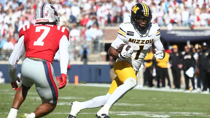 Oct 17, 2026; Oxford, Mississippi, USA; Missouri Tigers wide receiver Donovan Olugbode (1) carries the ball as Mississippi Rebels safety Sharif Denson (7) pursues during the first half at Vaught-Hemingway Stadium. Mandatory Credit: Petre Thomas-Imagn Images Oct 17, 2026; Oxford, Mississippi, USA; Missouri Tigers wide receiver Donovan Olugbode (1) carries the ball as Mississippi Rebels safety Sharif Denson (7) pursues during the first half at Vaught-Hemingway Stadium. Mandatory Credit: Petre Thomas-Imagn Images