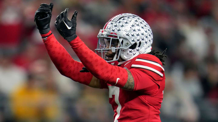 Dec 29, 2023; Arlington, Texas, USA; Ohio State Buckeyes cornerback Jordan Hancock (7) celebrates his sack of Missouri Tigers quarterback Brady Cook (12) in the fourth quarter during the Goodyear Cotton Bowl Classic at AT&T Stadium.