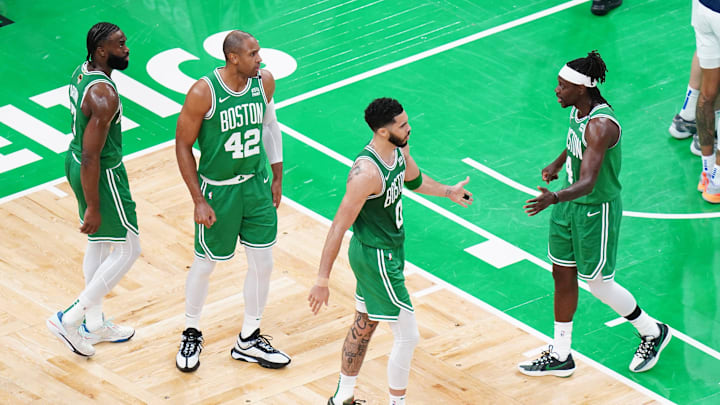Jun 17, 2024; Boston, Massachusetts, USA; Boston Celtics forward Jayson Tatum (0) and guard Jrue Holiday (4) react in the second quarter against the Dallas Mavericks during game five of the 2024 NBA Finals at TD Garden. Mandatory Credit: David Butler II-Imagn Images