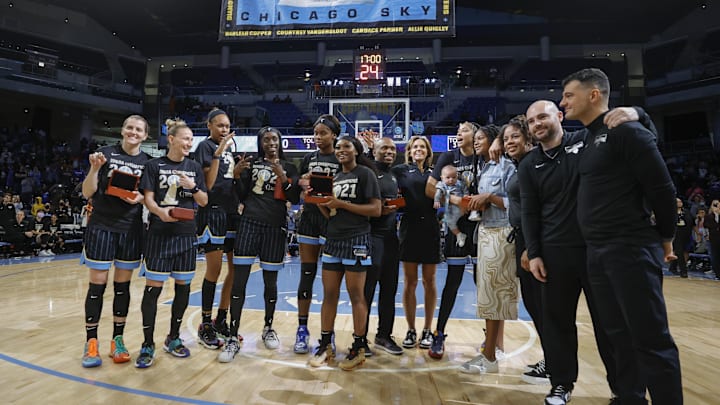 May 24, 2022; Chicago, Illinois, USA; Members of the Chicago Sky pose for a picture as the 2021 WNBA Championship Banner is revealed during a championship ring ceremony before a WNBA basketball game against the Indiana Fever at Wintrust Arena. Mandatory Credit: Kamil Krzaczynski-Imagn Images