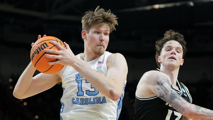 Mar 19, 2026; Greenville, SC, USA; North Carolina Tar Heels center Henri Veesaar (13) rebounds the ball against VCU Rams forward Lazar Djokovic (17) in the first half of a first round game of the men's 2026 NCAA Tournament at Bon Secours Wellness Arena. Mandatory Credit: Bob Donnan-Imagn Images