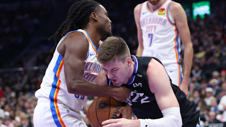 Nov 21, 2025; Salt Lake City, Utah, USA; Oklahoma City Thunder guard Cason Wallace (22) and Utah Jazz forward Kyle Filipowski (22) battle for the ball during the first half at Delta Center. Mandatory Credit: Rob Gray-Imagn Images