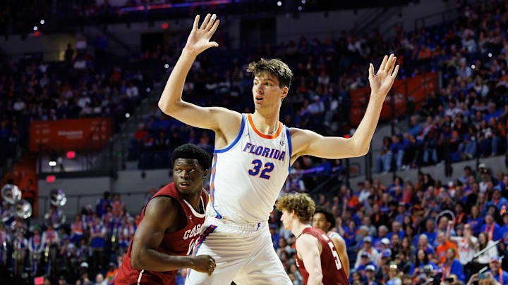 Dec 21, 2025; Gainesville, Florida, USA; Florida Gators center Olivier Rioux (32) calls for the ball while Colgate Raiders guard Josh Ahayere (4) defends during the second half at Exactech Arena at the Stephen C. O'Connell Center. Mandatory Credit: Matt Pendleton-Imagn Images