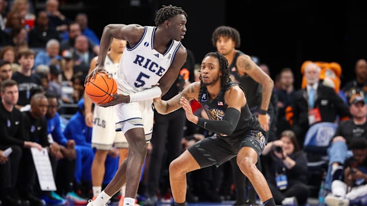 Feb 26, 2025; Memphis, Tennessee, USA; Rice Owls guard Jacob Dar (5) handles the ball against Memphis Tigers guard Colby Rogers (3) during the first half at FedExForum. Feb 26, 2025; Memphis, Tennessee, USA; Rice Owls guard Jacob Dar (5) handles the ball against Memphis Tigers guard Colby Rogers (3) during the first half at FedExForum.