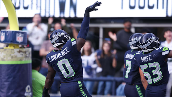 Seattle Seahawks defensive end DeMarcus Lawrence celebrates after recovering a fumble to score a touchdown.