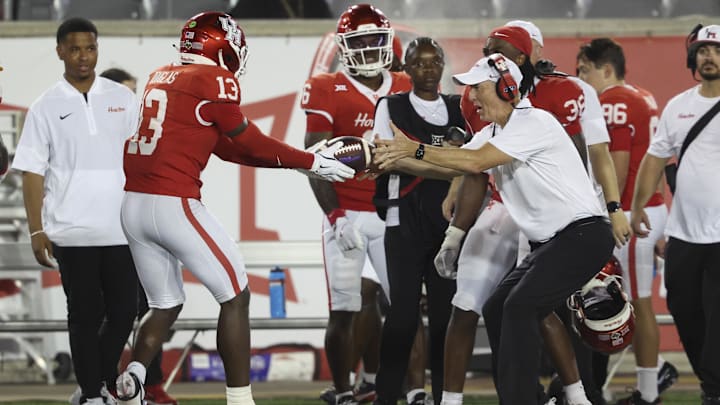 Aug 28, 2025; Houston, Texas, USA; Houston Cougars defensive back C.J. Douglas (13) hands the ball to head coach Willie Fritz after an interception during the fourth quarter against the Stephen F. Austin Lumberjacks at TDECU Stadium. Mandatory Credit: Troy Taormina-Imagn Images Aug 28, 2025; Houston, Texas, USA; Houston Cougars defensive back C.J. Douglas (13) hands the ball to head coach Willie Fritz after an interception during the fourth quarter against the Stephen F. Austin Lumberjacks at TDECU Stadium. Mandatory Credit: Troy Taormina-Imagn Images