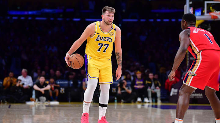 Mar 4, 2025; Los Angeles, California, USA; Los Angeles Lakers guard Luka Doncic (77) controls the ball against New Orleans Pelicans forward Zion Williamson (1) during the first half at Crypto.com Arena. Mandatory Credit: Gary A. Vasquez-Imagn Images Mar 4, 2025; Los Angeles, California, USA; Los Angeles Lakers guard Luka Doncic (77) controls the ball against New Orleans Pelicans forward Zion Williamson (1) during the first half at Crypto.com Arena. Mandatory Credit: Gary A. Vasquez-Imagn Images