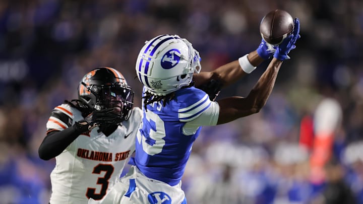 Oct 18, 2024; Provo, Utah, USA; Brigham Young Cougars wide receiver Jojo Phillips (13) reaches for a pass against Oklahoma State Cowboys cornerback Cam Smith (3) during the first quarter at LaVell Edwards Stadium. Mandatory Credit: Rob Gray-Imagn Images Oct 18, 2024; Provo, Utah, USA; Brigham Young Cougars wide receiver Jojo Phillips (13) reaches for a pass against Oklahoma State Cowboys cornerback Cam Smith (3) during the first quarter at LaVell Edwards Stadium. Mandatory Credit: Rob Gray-Imagn Images