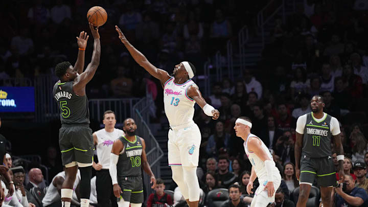 Mar 7, 2025; Miami, Florida, USA;  Minnesota Timberwolves guard Anthony Edwards (5) shoots over Miami Heat center Bam Adebayo (13) during the first half at Kaseya Center. Mandatory Credit: Jim Rassol-Imagn Images