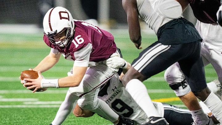 Ankeny Centennial's Mitchell Grider (9) makes a stop on Dowling's Joey Nahas (16) on Friday, Nov. 8, 2024, at Mediacom Stadium.
