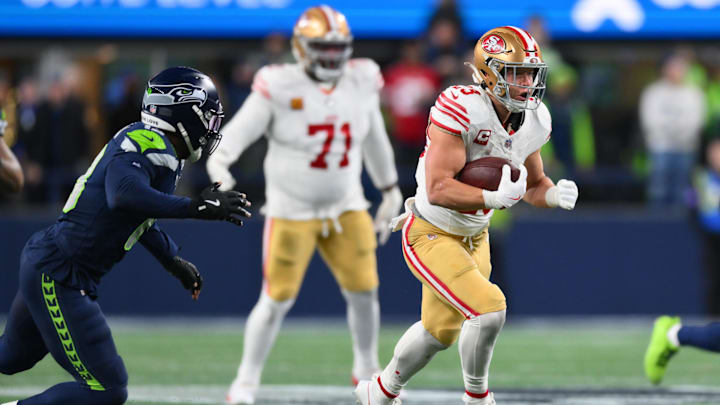 Jan 17, 2026; Seattle, WA, USA; San Francisco 49ers running back Christian McCaffrey (23) runs after the catch against the Seattle Seahawks during the first half in an NFC Divisional Round game at Lumen Field. Mandatory Credit: Steven Bisig-Imagn Images
