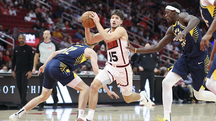 Nov 20, 2024; Houston, Texas, USA; Houston Rockets guard Reed Sheppard (15) attempts to drive with the ball past Indiana Pacers forward Johnny Furphy (12) during the second quarter at Toyota Center. Mandatory Credit: Troy Taormina-Imagn Images