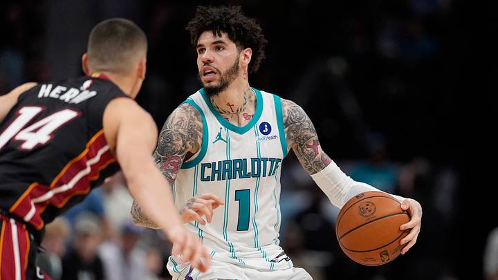 Charlotte Hornets guard LaMelo Ball (1) looks to pass defended by Miami Heat guard Tyler Herro (14) during the second half during the play-in rounds between the Charlotte Hornets and the Miami Heat of the 2026 NBA Playoffs at Spectrum Center. Mandatory Credit: Jim Dedmon-Imagn Images