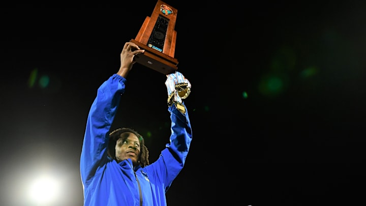 Miami Northwestern's Teddy Bridgewater raises the state trophy following the team's win over Raines in the Class 3A championship on Dec. 14, 2024.