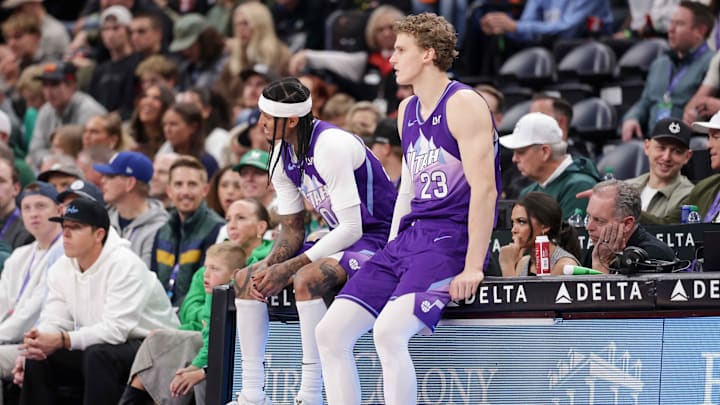 Mar 17, 2025; Salt Lake City, Utah, USA;  Utah Jazz guard Jordan Clarkson (00) and forward Lauri Markkanen (23) sit not he scorers table during the second quarter against the Chicago Bulls at Delta Center. Mandatory Credit: Chris Nicoll-Imagn Images