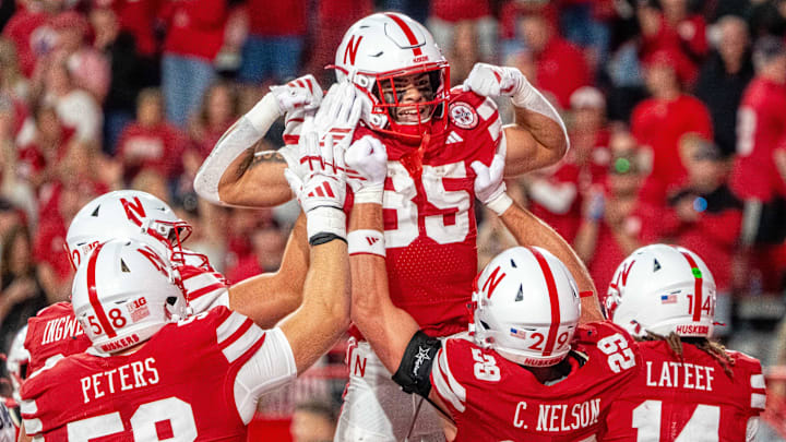 Sep 6, 2025; Lincoln, Nebraska, USA; Nebraska Cornhuskers running back Mekhi Nelson (35) is hoisted by tight end Carter Nelson (29) after scoring a touchdown against the Akron Zips during the fourth quarter at Memorial Stadium. Mandatory Credit: Dylan Widger-Imagn Images