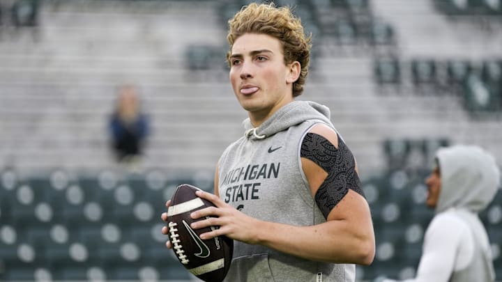 Nov 15, 2025; East Lansing, Michigan, USA; Michigan State quarterback Alessio Milivojevic (11) sticks his tongue out during warmups before a game against the Penn State Nittany Lions at Spartan Stadium. Mandatory Credit: Brendan Mullin-Imagn Images Nov 15, 2025; East Lansing, Michigan, USA; Michigan State quarterback Alessio Milivojevic (11) sticks his tongue out during warmups before a game against the Penn State Nittany Lions at Spartan Stadium. Mandatory Credit: Brendan Mullin-Imagn Images