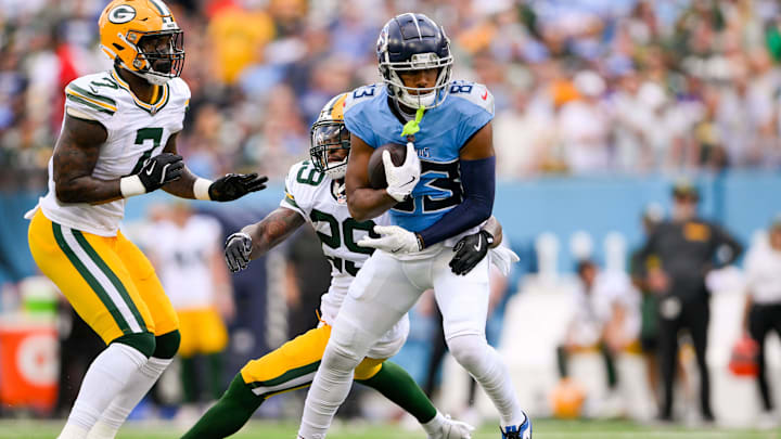 Sep 22, 2024; Nashville, Tennessee, USA;  Green Bay Packers safety Xavier McKinney (29) tackles Tennessee Titans wide receiver Tyler Boyd (83) after a made catch during the first half at Nissan Stadium.