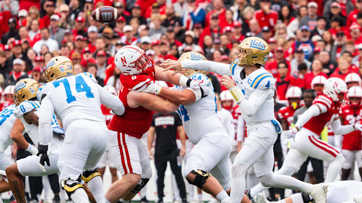 Nov 2, 2024; Lincoln, Nebraska, USA; UCLA Bruins quarterback Ethan Garbers (4) throws a pass against Nebraska Cornhuskers defensive lineman Nash Hutmacher (0) during the first quarter at Memorial Stadium. Mandatory Credit: Dylan Widger-Imagn Images