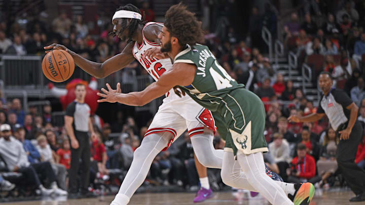 Oct 12, 2025; Chicago, Illinois, USA;  Chicago Bulls forward Mouhamadou Gueye (16) and Milwaukee Bucks guard Andre Jackson Jr. (44) chase a loose ball