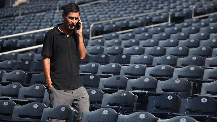 Oct 17, 2022; San Diego, CA, USA; San Diego Padres general manager AJ Preller speaks on the phone during NLCS workouts at Petco Park. Mandatory Credit: Orlando Ramirez-Imagn Images