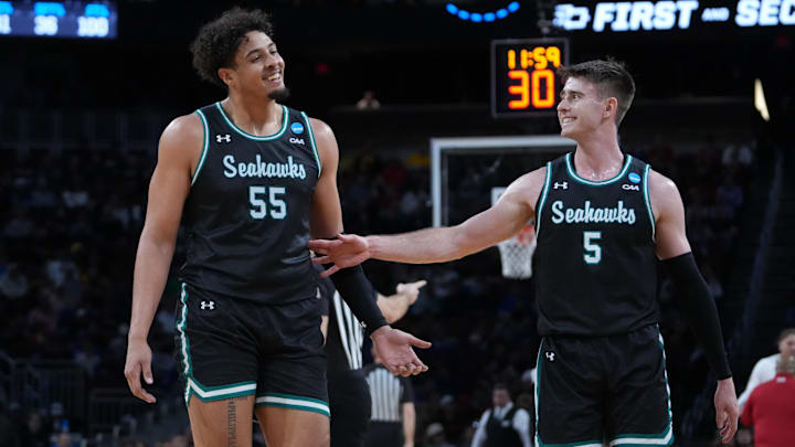 Mar 20, 2025; Wichita, KS, USA; North Carolina-Wilmington Seahawks forward Harlan Obioha (55) and guard Noah Ross (5) react after a play in the first half of a first round men’s NCAA Tournament game against the Texas Tech Red Raiders at Intrust Bank Arena. Mandatory Credit: Kirby Lee-Imagn Images