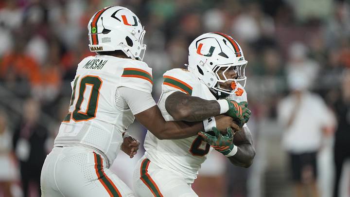 Sep 4, 2026; Stanford, California, USA; Miami Hurricanes quarterback Darian Mensah (10) hands off to running back CharMar Brown (6) against the Stanford Cardinal during the third quarter at Stanford Stadium. Mandatory Credit: Stan Szeto-Imagn Images Sep 4, 2026; Stanford, California, USA; Miami Hurricanes quarterback Darian Mensah (10) hands off to running back CharMar Brown (6) against the Stanford Cardinal during the third quarter at Stanford Stadium. Mandatory Credit: Stan Szeto-Imagn Images